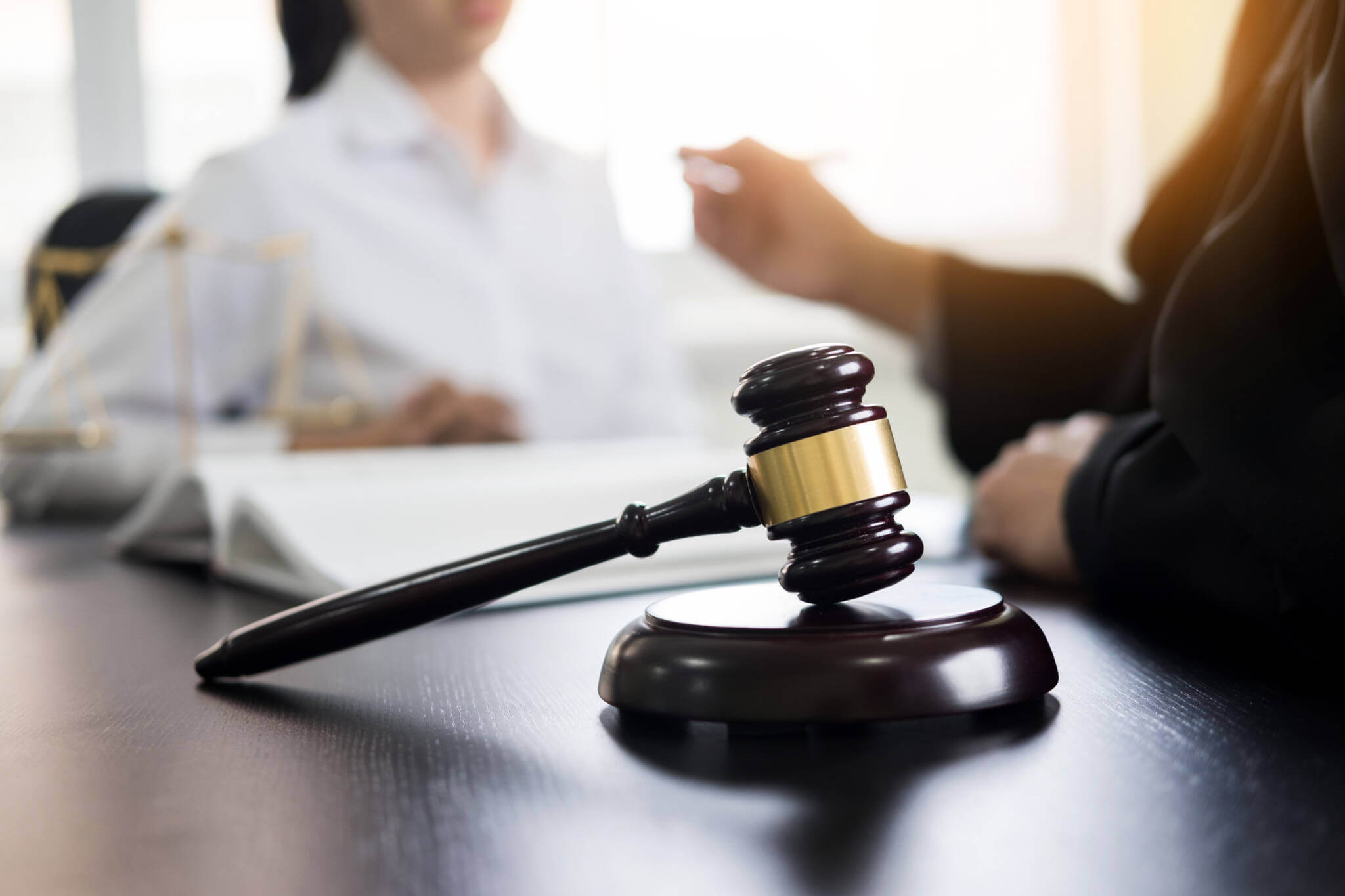 Judge Gavel With Lawyers Advice Legal At Law Firm In Background. Concepts Of Law, Services.